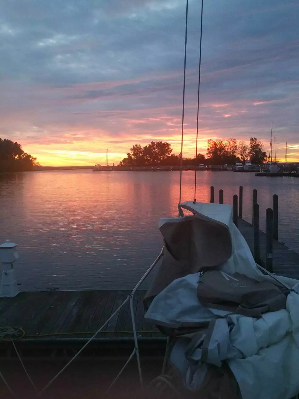 A sailboat at a dock Middle Bass Island in a sunset